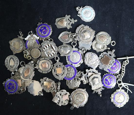 A collection of silver fobs/medallions.